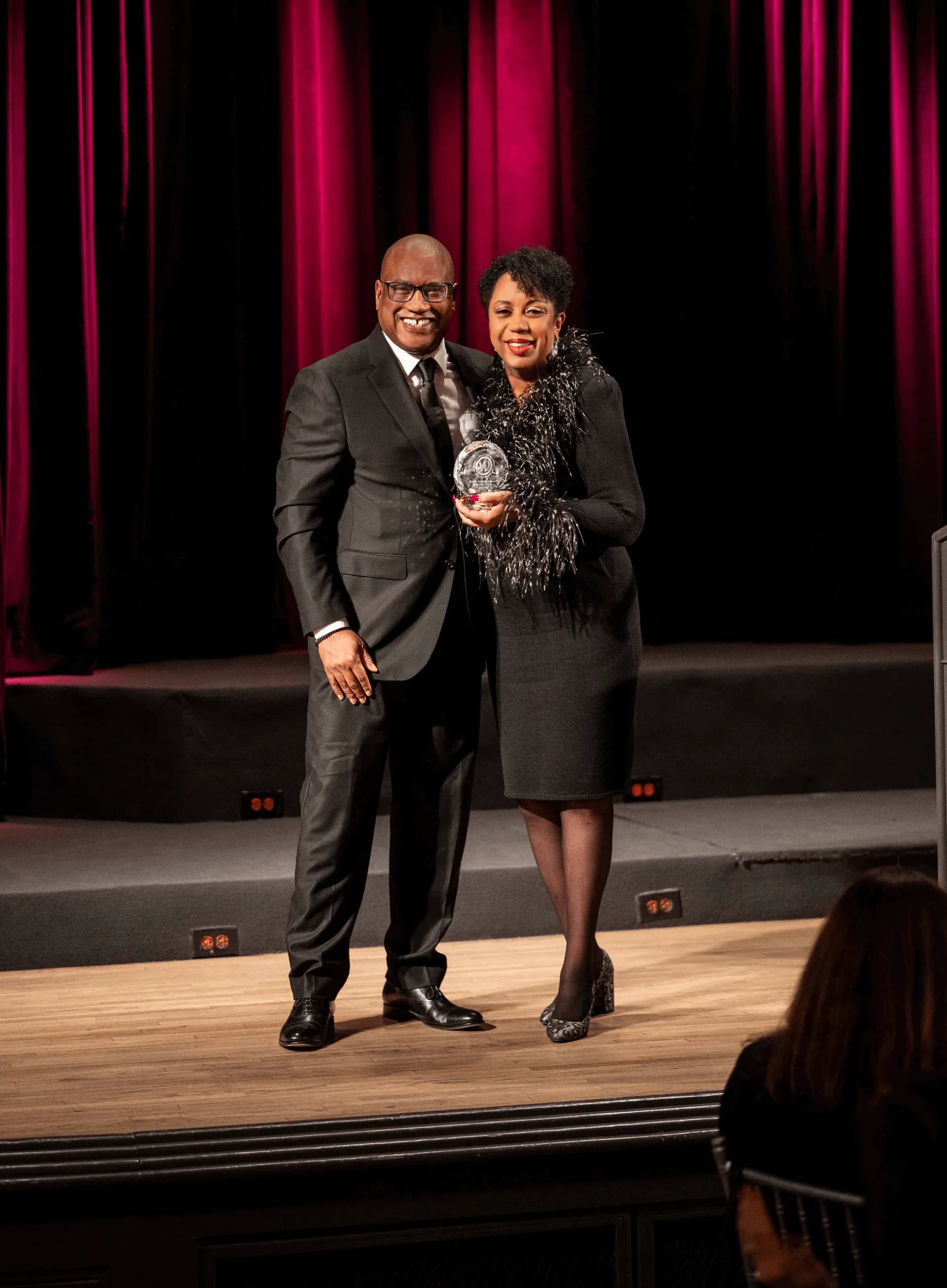 Sharon receiving the NAWBO Hall of Fame award on stage